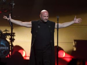 Disturbed frontman David Draiman performing on stage.