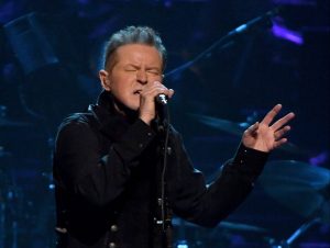 Don Henley of the Eagles performing on stage.