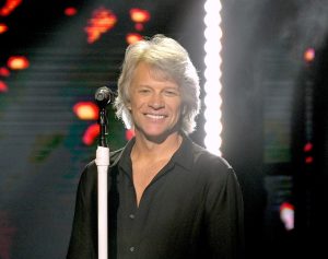 Jon Bon Jovi performing on stage.