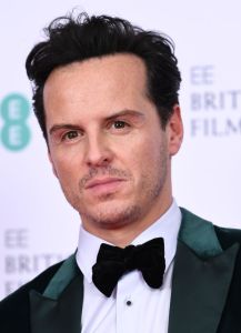 Andrew Scott wearing a green suit with a bowtie in this close-up shot.
