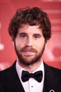 Close-up photo of Ben Platt wearing a black suit and bowtie.