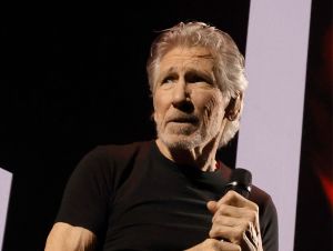 Roger Waters performing on stage.