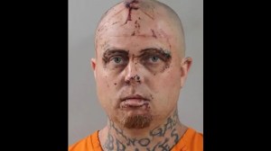 mugshot of Caucasian man, bald with blooded face