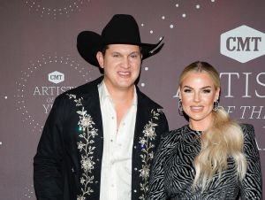 Jon Pardi on a black suit and hat, his wife Summer in a black dress