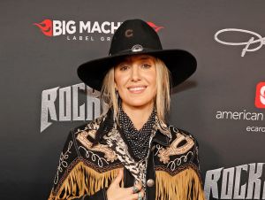 Lainey Wilson in a black cowboy jacket and hat