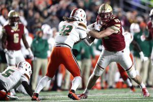 Sheldrick Redwine #22 of the Miami Hurricanes defends Tommy Sweeney #89 of the Boston College Eagles at Alumni Stadium