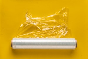 roll of wrapping stretch film for packing at colorful background isolated