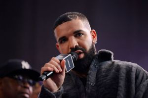 Drake holding a microphone at the Till Death Do Us Part Rap Battle Event