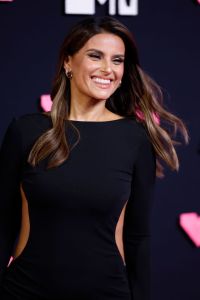 Nelly Furtado attends the 2023 MTV Video Music Awards smiling wearing a black cutout dress.