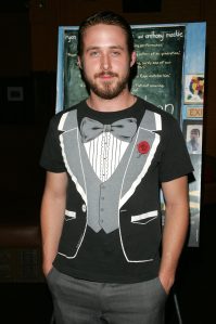 Ryan Gosling attends the Think Films premiere of "Half Nelson" wearing a tuxedo graphic tee shirt with his hands in his pockets.