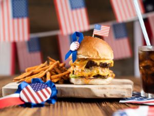 American flag and decorations. Burgers on rustic wooden table, Veterans Day concept