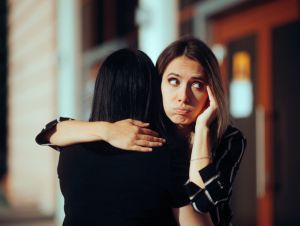 Backstabbing toxic girlfriend embracing someone with bad intentions, unreliable concept.
