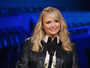 Miranda Lambert in a black jacket and white and black western shirt