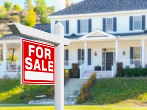 For Sale Real Estate Sign in Front of New House.