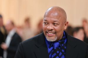 Dr. Dre attends The 2023 Met Gala Celebrating "Karl Lagerfeld: A Line Of Beauty" looking left smiling wearing a blue and black patterned shirt.