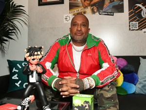 Kenya Barris attends as DJ Drama and Glen Infante kick off Hip-Hop Sounds & Stories presented by NTWRK, Audible and Amazon Music at NTWRK LA on August 24, 2023 in Los Angeles, California. Barris sitting on couch with merch infront of him on table.