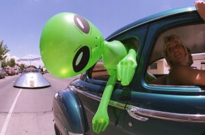 Blow up green alien with head about the window. The first Interstellar travel ad was just sent out