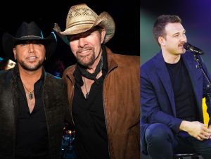 Jason Aldean is in. a black jacket with Toby Keith in a brown jacket and Morgan Wallen on stage wearing a black suit.