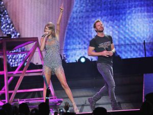 Taylor Swift was on stage in a silver dress with Dierks Bentley in a black t-shirt and jeans.