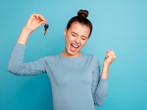 Portrait of delighted lady luck lucky triumph raise fists close eyes content rejoice scream shout yeah mover move in settlement loan beautiful bun trendy stylish sweater isolated on blue background