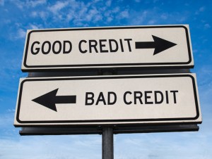 Good credit and bad credit road sign. White two street signs with arrow on metal pole with word. Directional road. Crossroads Road Sign, Two Arrow. Blue sky background. Two way road sign with text.