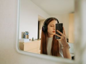 A woman taking a selfie in the mirron.