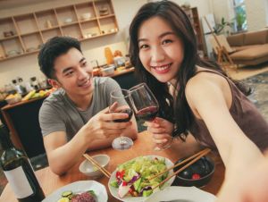 Couple enjoying wine and dinner.