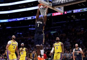 Zion Williamson #1 of the New Orleans Pelicans dunks in front of Anthony Davis #3 and LeBron James #6 of the Los Angeles Lakers