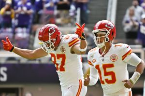 Travis Kelce #87 of the Kansas City Chiefs and Patrick Mahomes #15 of the Kansas City Chiefs run onto the filed prior to a game