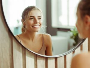 A young woman looking in the mirror.