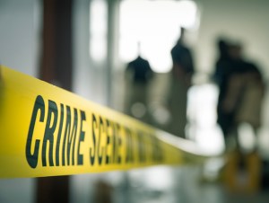 Crime scene tape with blurred forensic in cinematic tone