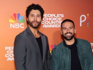 Dan + Shay's 'Bigger Houses' - Dan Smyers in a black blazer and shirt and Shay Mooney in a green jacket and black shirt.