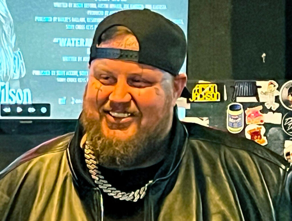 Jelly Rol's Father - Jelly Roll, wearing a black jacket and a black ball cap. 