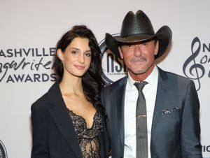 Tim McGraw's daughter - Tim, is in a gray suit and hat with his daughter, Audrey, in a black outfit.