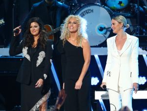 The 2024 CMT Music Awards - Karen Fairchild in black and Kimberly Schlapman in black with Jennifer Nettles in a white suit on stage.