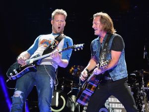 Tyler Hubbard's Solo Career - Brian Kelley and Tyler Hubbard of FGL perform on stage wearing jeans and t-shirts.s in 2013.