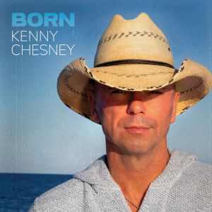 Kenny Chesney in a straw cowboy hat and gray shirt on his album cover for "Born."