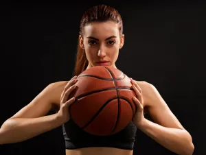 A woman holding a basketball, getting ready for March Madness brackets.