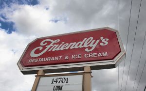 A Friendly's Ice Cream Corp restaurant sign under a cloudy sky. The last Friendly's in Boston has closed.
