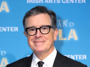 Stephen Colbert attends the 2023 Spirit Of Ireland Gala slightly smiling wearing a black suit, Stephen Colbert Apologizes About Kate Middleton Jokes.