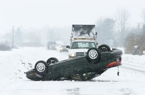 Car turned upside down on the highway. An impaired driver ran destroyed a "report impaired drivers" sign