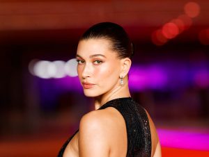Hailey Bieber attends the Academy Museum of Motion Pictures 3rd Annual Gala looking back, wearing a black sleeveless gown, Hailey Bieber Shares Beyonce’s Jolene, Sparks Backlash.