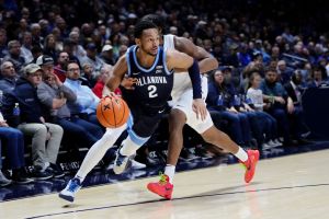 Mark Armstrong #2 of the Villanova Wildcats dribbles the ball while being guarded by Quincy Olivari #8 of the Xavier Musketeers