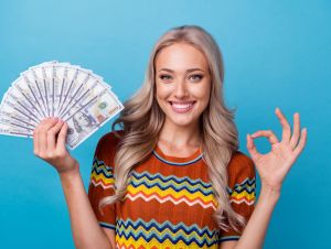 A woman smiling with money