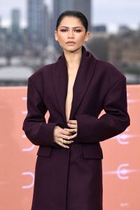 Zendaya attends the London photocall for "Dune: Part Two" wearing a plunging suit.