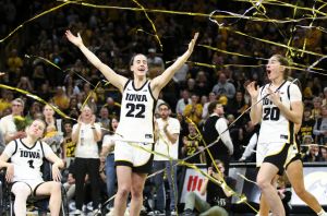 Guard Caitlin Clark #22 and guard Kate Martin #20 of the Iowa Hawkeyes celebrates in the confetti after senior day festivities after the match-up against Ohio State.