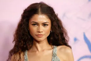 Zendaya attends the 2024 Green Carpet Fashion Awards with her curly hair worn down looking left wearing a grey gown as 8 Times Zendaya Looked Sultry, Sexy & Sweet.