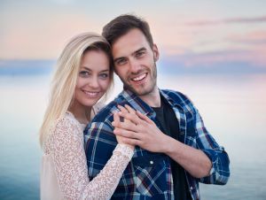 Beautiful couple hugging during sunset.