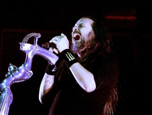 Jonathan Davis of Korn performing on stage.