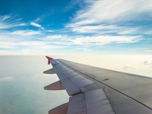 An airplane wing flying in the clouds. A new airline is debuting two new South Carolina airline routes.